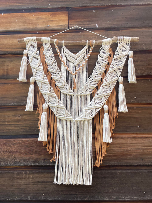 décoration murale style bohème chic blanc et marron beige en corde de coton et bois flotté avec six pompons accrochés sur l'extérieur réalisé avec la technique macramé